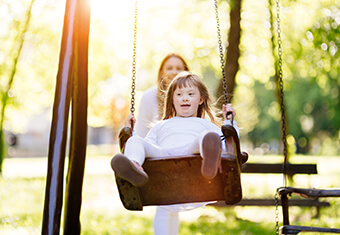 Disabled child enjoying the swing