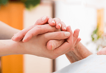 clasping hand of ill person hospital hospice