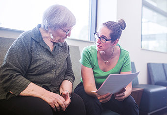 Senior Adult Woman Filling Out Paperwork