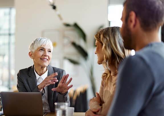 Image of legal advisor speaking to man and woman.