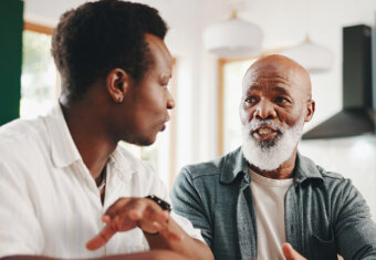 Photo of father and son having a conversation.