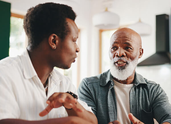 Photo of father and son having a conversation.
